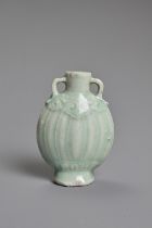 A CHINESE PALE CELADON GLAZED MINIATURE PORCELAIN BOTTLE, 19TH CENTURY. Of flattened ovoid form with