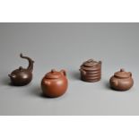 FOUR CHINESE YIXING POTTERY TEAPOTS, 20TH CENTURY OR LATER. Of varying sizes and forms each with