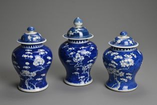 THREE CHINESE BLUE AND WHITE PRUNUS JARS AND COVERS, 19/20TH CENTURY. Each of baluster form with