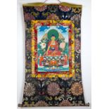 A TIBETAN THANGKA, 20TH CENTURY. Polychrome painted on canvas depicting an image of Buddha with