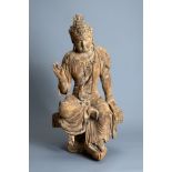 A FINE CHINESE PAINTED WOOD FIGURE OF GUANYIN, MING DYNASTY. Seated on an openwork pedestal with