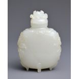 A CHINESE MUGHAL STYLE WHITE JADE SNUFF BOTTLE WITH COVER. Very finely hollowed and carved in relief