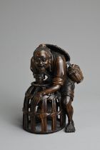 A JAPANESE CARVED WOOD MODEL OF A FISHERMAN, PROBABLY LATE 19TH/20TH CENTURY. Modelled bent over,