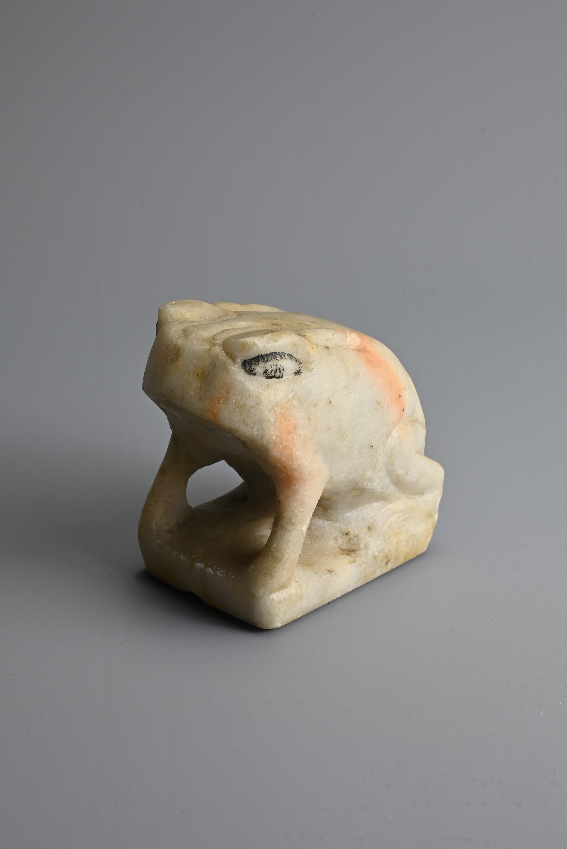 A CHINESE WHITE MABLE MODEL OF A FROG, TANG DYNASTY OR LATER. Seated on a rectangular base with