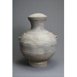 A LARGE CHINESE GREY POTTERY HU JAR WITH COVER, WESTERN HAN DYNASTY (206 BC – AD 8). Heavily