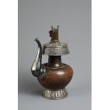 A TIBETAN COPPER AND SILVER EWER, BUMPA, 19/20TH CENTURY. With copper body and splayed silver foot