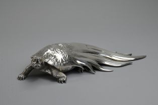 A 20TH CENTURY JAPANESE SILVER OKIMONO OF A MINOGAME. The mythical turtle depicted with a typical