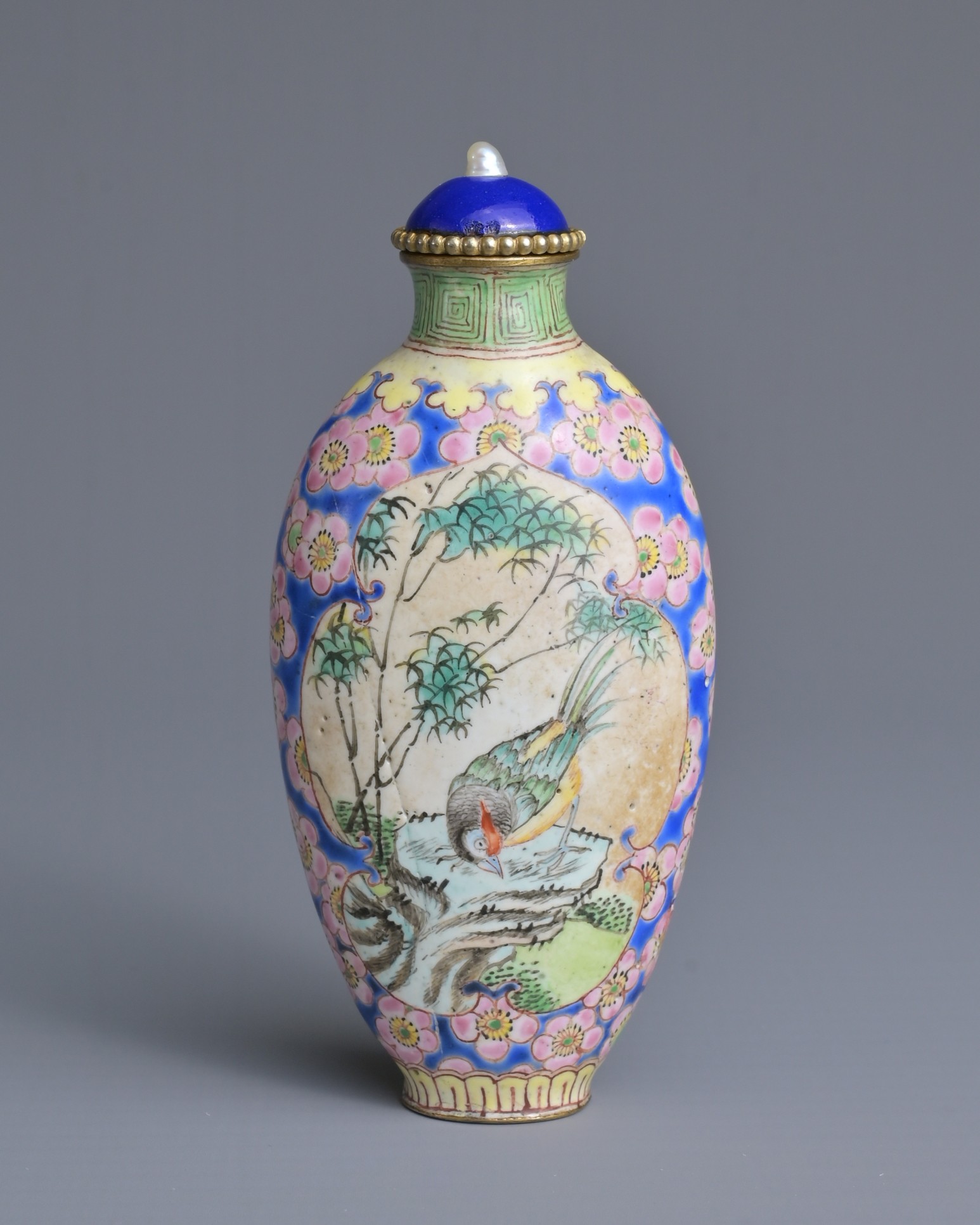 A CHINESE PAINTED ENAMEL SNUFF BOTTLE, QING DYNASTY. Tall ovoid form decorated with cartouche panels