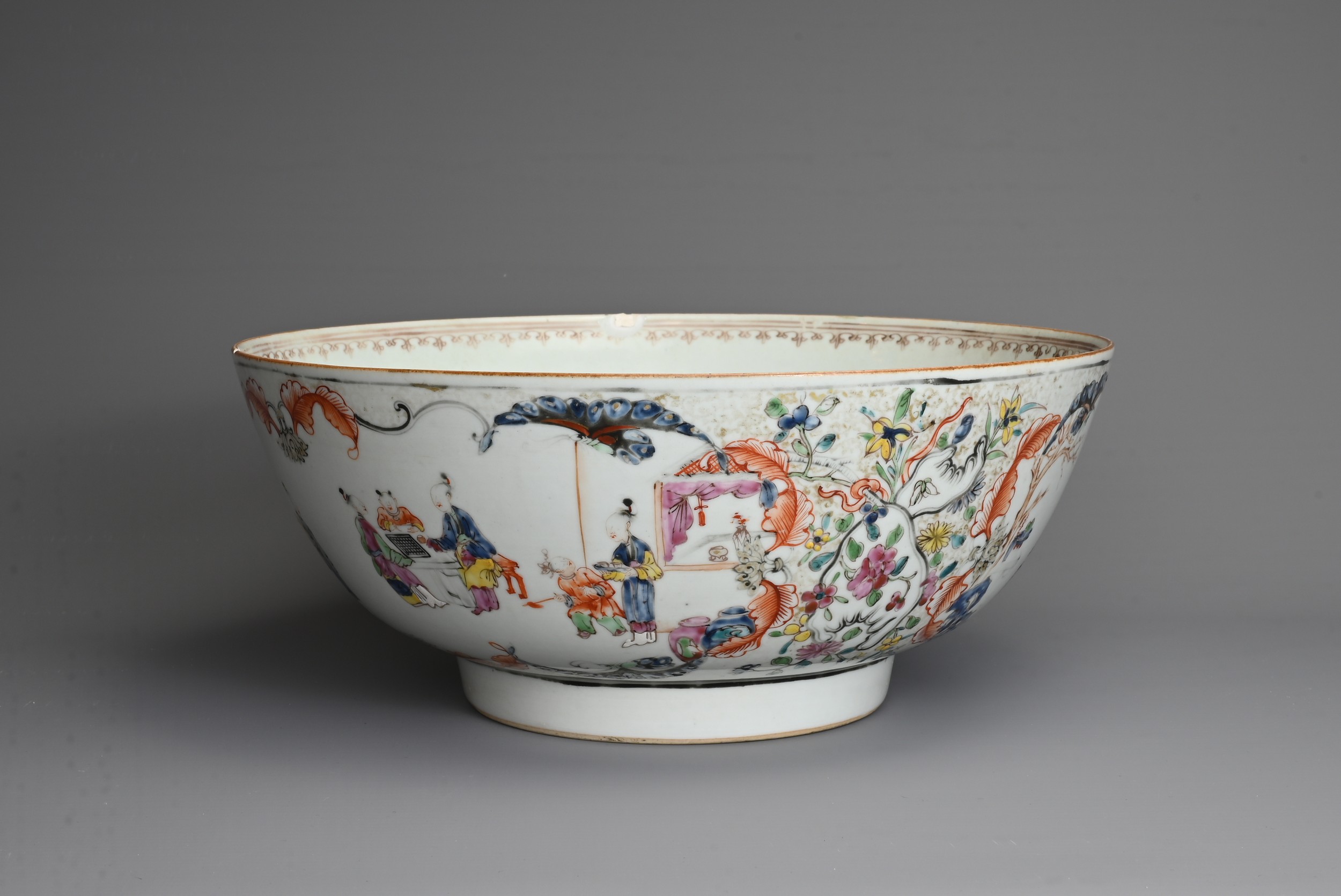 A CHINESE FAMILLE ROSE PORCELAIN PUNCH BOWL, 18TH CENTURY. Decorated with figures in a courtyard