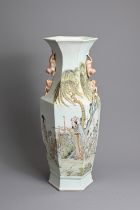 A CHINESE FAMILLE ROSE HEXAGONAL PORCELAIN VASE, 20TH CENTURY. Of baluster form with lion handles,