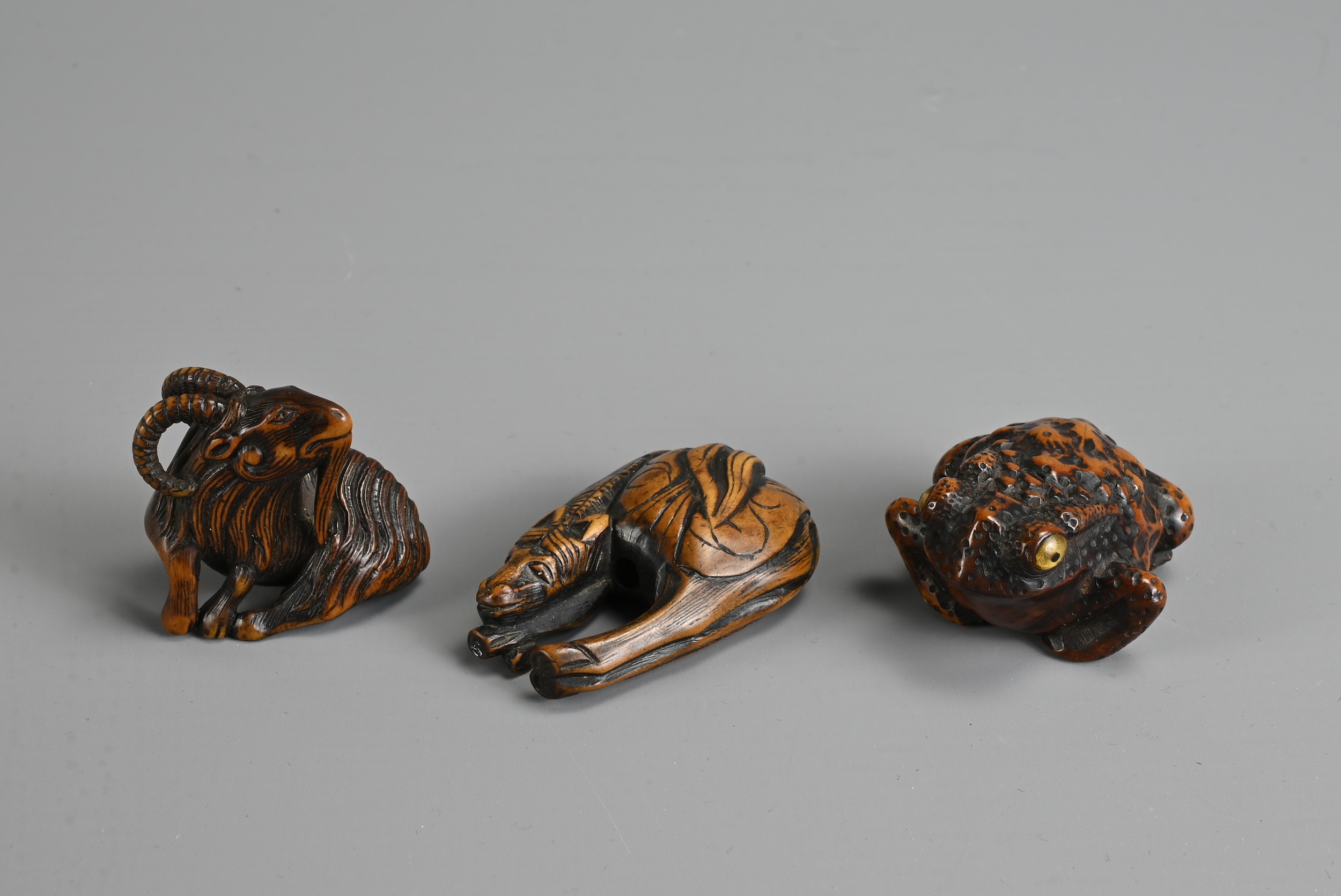 THREE 19TH CENTURY JAPANESE CARVED BOXWOOD NETSUKE. Comprising: a model of a goat, signed Kokei (