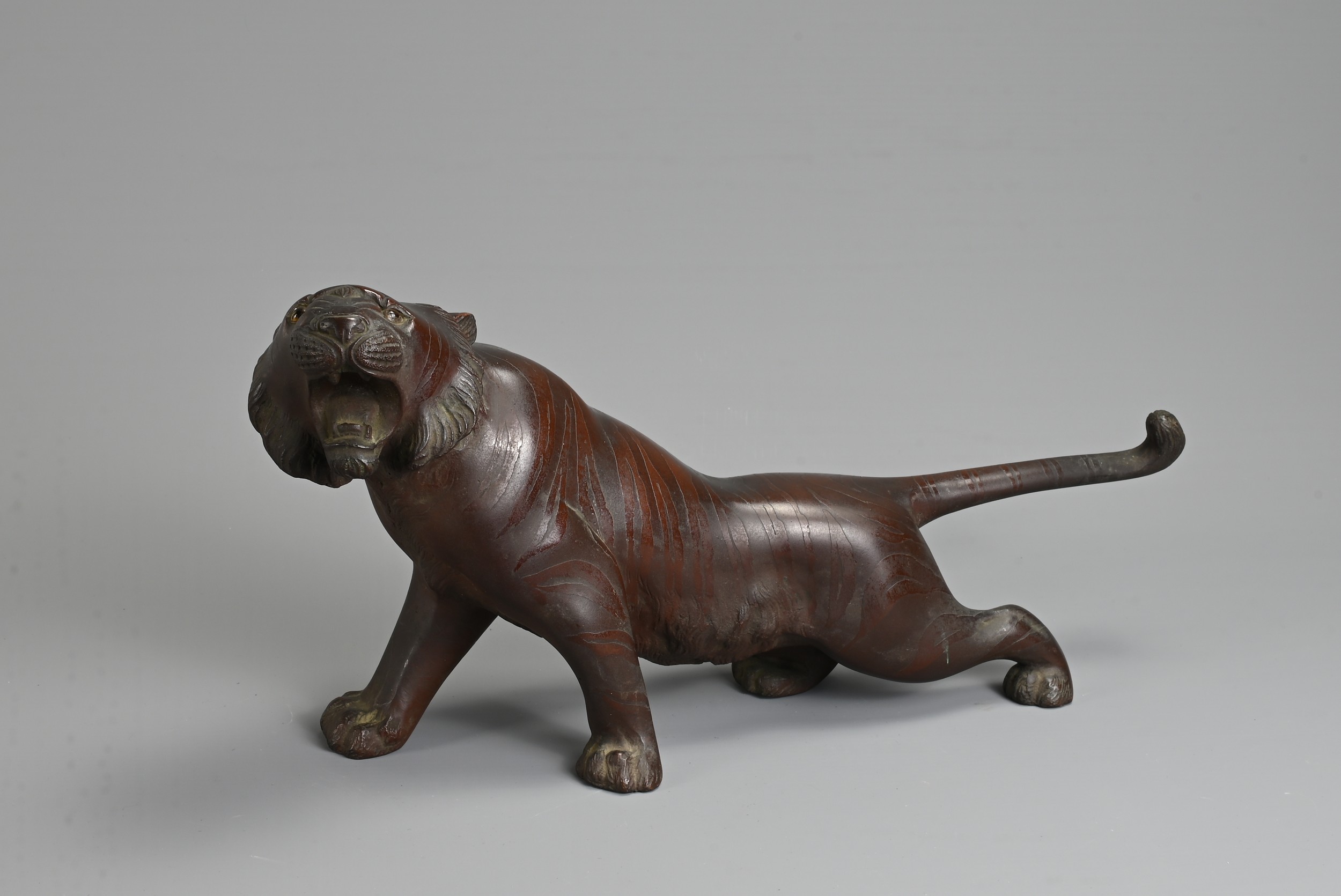 A LATE 19TH/EARLY 20TH CENTURY JAPANESE BRONZE OKIMONO OF A TIGER BY NOBUMITSU. Naturalistically