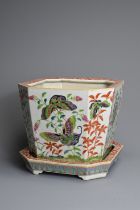 A CHINESE FAMILLE ROSE OCTAGONAL PORCELAIN JARDINIERE AND TRAY, CIRCA 1900. The planter on four feet