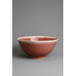 A CHINESE PEACH BLOOM GLAZED PORCELAIN BOWL, 18TH CENTURY. Rounded body with a gently everted rim