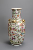 A CHINESE CANTON FAMILLE ROSE PORCELAIN VASE, 19TH CENTURY. Of baluster form with four gilt lion