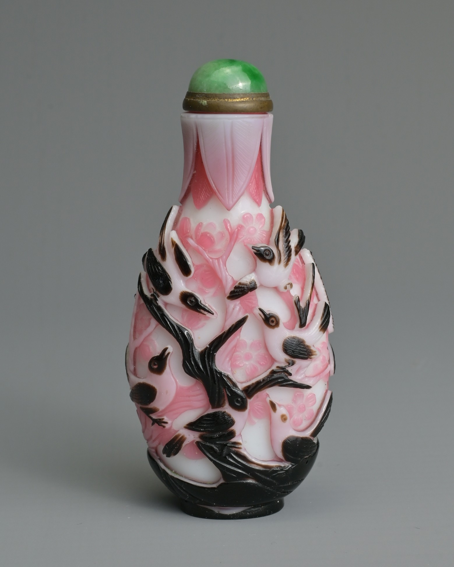 A CHINESE BLACK OVERLAY PINK AND WHITE SNUFF BOTTLE, QING DYNASTY. Of flattened ovoid form, well