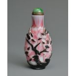 A CHINESE BLACK OVERLAY PINK AND WHITE SNUFF BOTTLE, QING DYNASTY. Of flattened ovoid form, well
