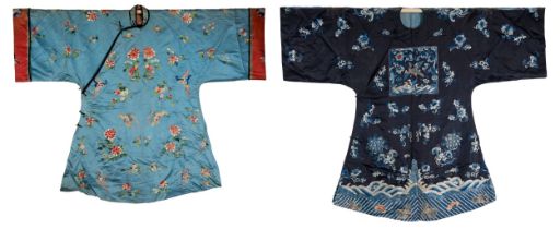TWO CHINESE EMBROIDERED BLUE-GROUND SILK ROBES, CIRCA 1900 AND LATER. The first, earlier example, of