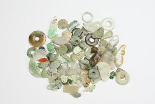 A QUANTITY OF JADE PENDANTS AND HAT FITTINGS, 19/20TH CENTURY. Of various colours and forms to