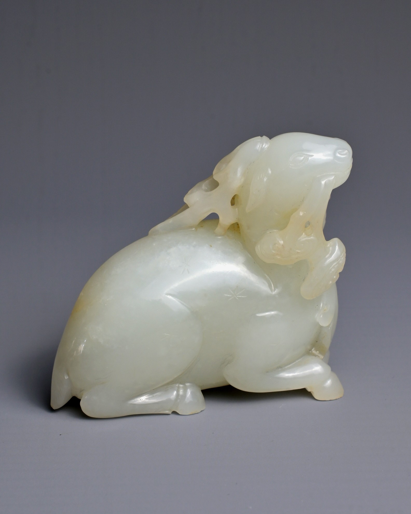 A CHINESE WHITE JADE CARVING OF A DEER, QING DYNASTY. Carved and pierced in the form of a