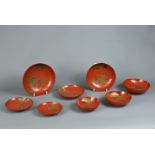 A GROUP OF EIGHT 20TH CENTURY JAPANESE RED LACQUER SAKE CUPS IN SIZES