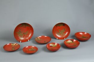 A GROUP OF EIGHT 20TH CENTURY JAPANESE RED LACQUER SAKE CUPS IN SIZES