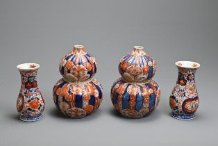 TWO PAIRS OF 19TH CENTURY JAPANESE IMARI VASES. The first of reeded double gourd-shape, moulded with