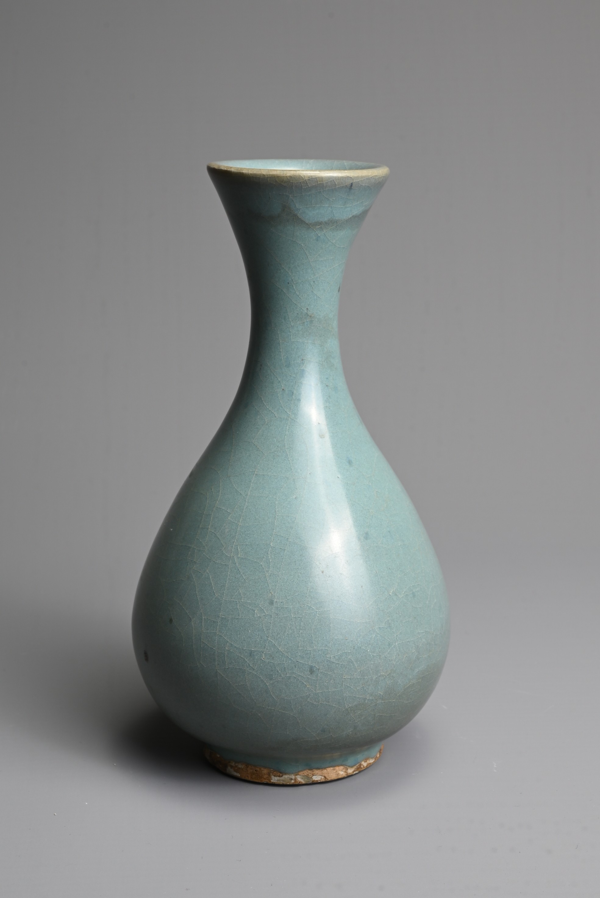 A CHINESE JUN TYPE BOTTLE VASE, SONG / YUAN DYNASTY. Pear shaped bottle with flared rim covered in a