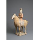 A CHINESE PAINTED POTTERY HORSE WITH MUSICIAN, TANG DYNASTY (618-907). The horse standing four