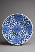 A LARGE CHINESE BLUE AND WHITE PORCELAIN DISH, QING DYNASTY. Decorated with large peony blooms