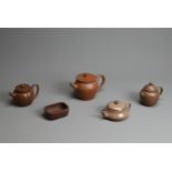 A GROUP OF CHINESE YIXING POTTERY, 20TH CENTURY. To include four teapots of varying forms each