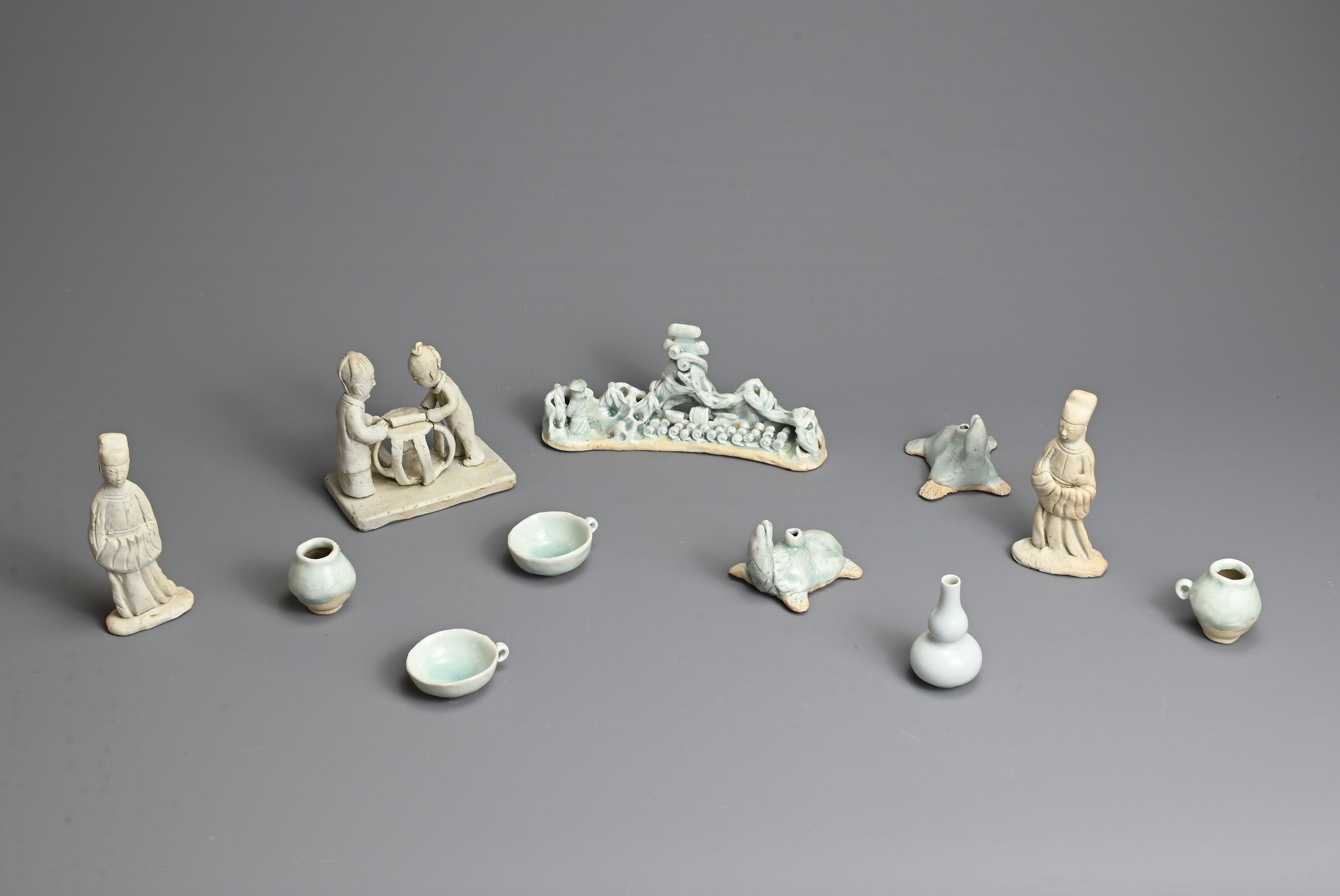A GROUP OF CHINESE QINGBAI WARE AND BISCUIT PORCELAIN ITEMS. To include a pair of glazed joss