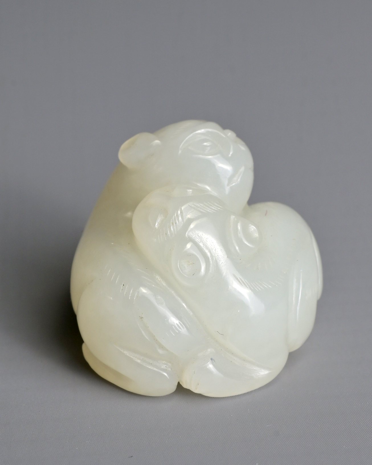 A CHINESE WHITE JADE LION GROUP PENDANT, QING DYNASTY. Carved in the form with two recumbent lions