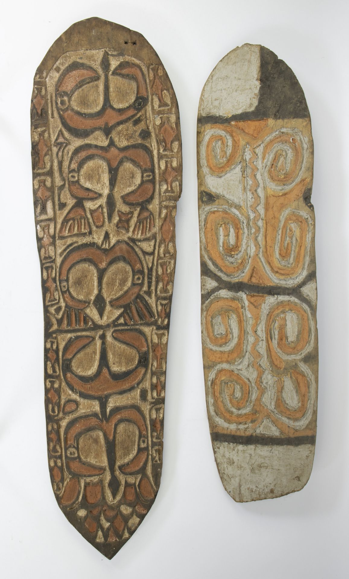 Wooden polychrome shields (2) of the Asmat, wooden reincarnation of ancestors, Papua New Guinea