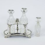 A silver-plated oil and vinegar set with marks and a small oil bottle