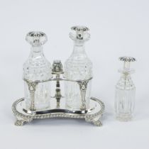 A silver-plated oil and vinegar set with marks and a small oil bottle