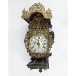Friesian stool clock with polychrome painted case finished with rocailles, lions, garlands and figur