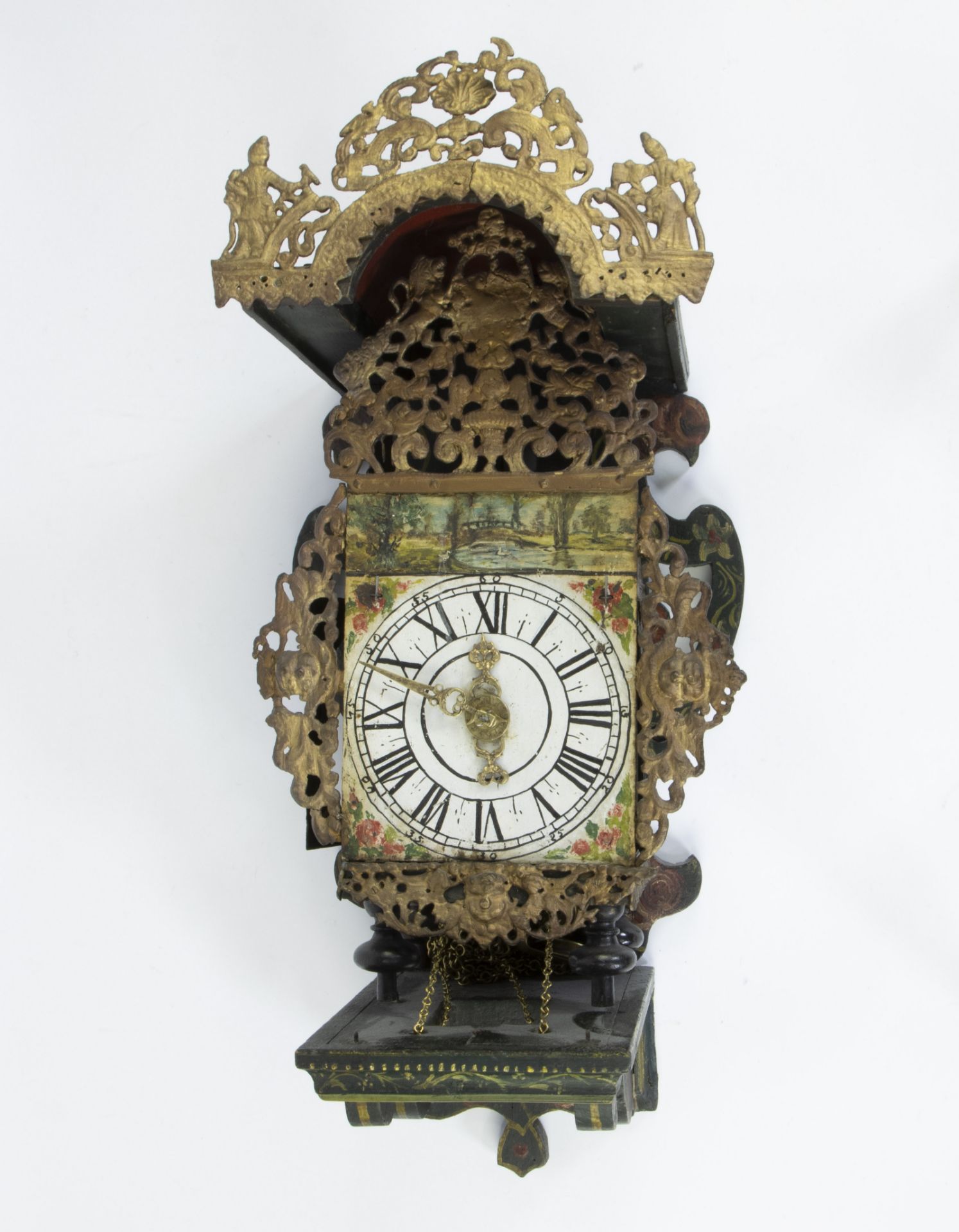 Friesian stool clock with polychrome painted case finished with rocailles, lions, garlands and figur