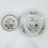 Chinese famille rose dinner plate and a smaller dish, the plate decorated with garden decor, an exot