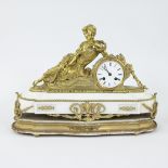 French ormolu and white marble mantle clock surmounted by a reclining figure on a stepped marble bas