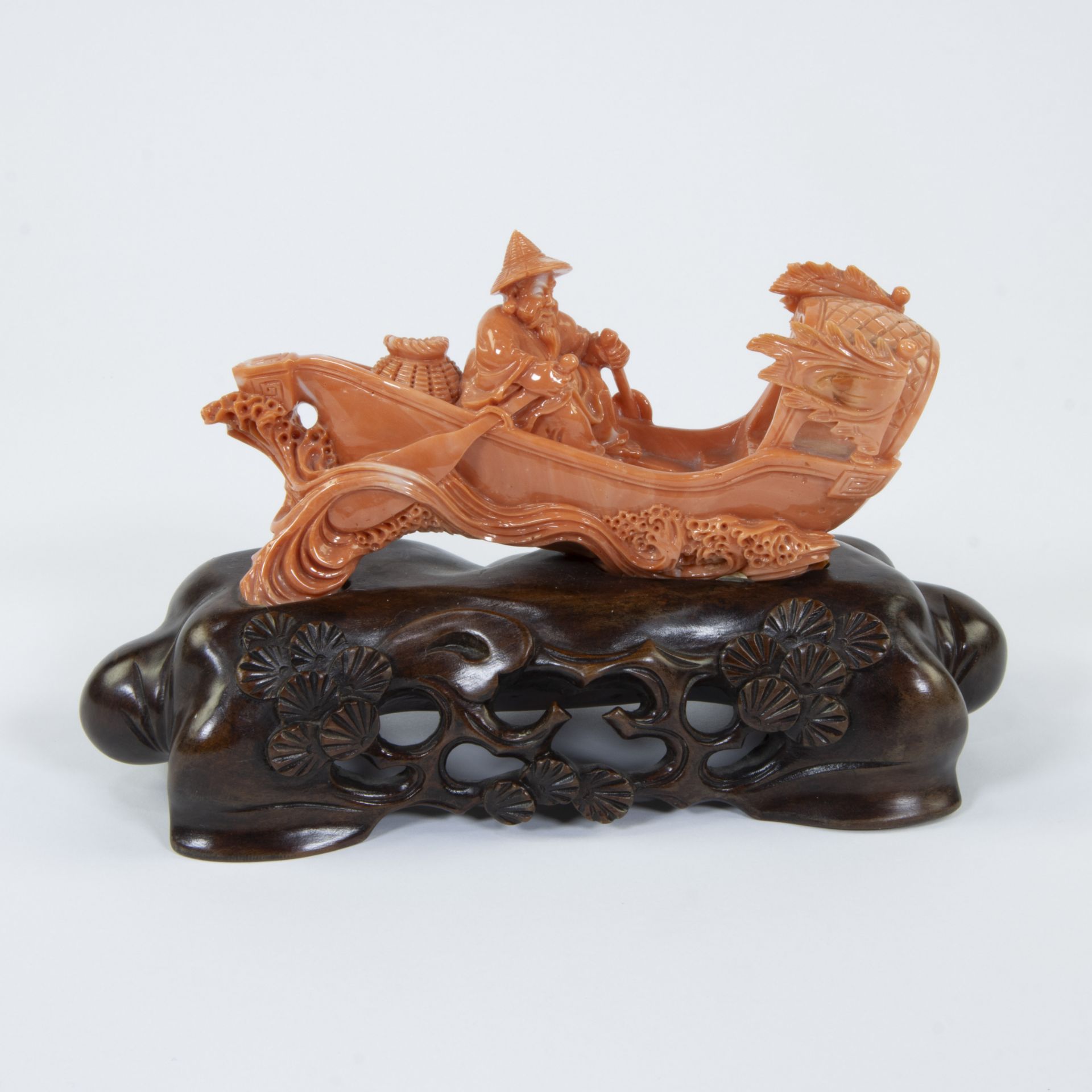 A Chinese group in red coral with an oarsman and boat, 19/20th century