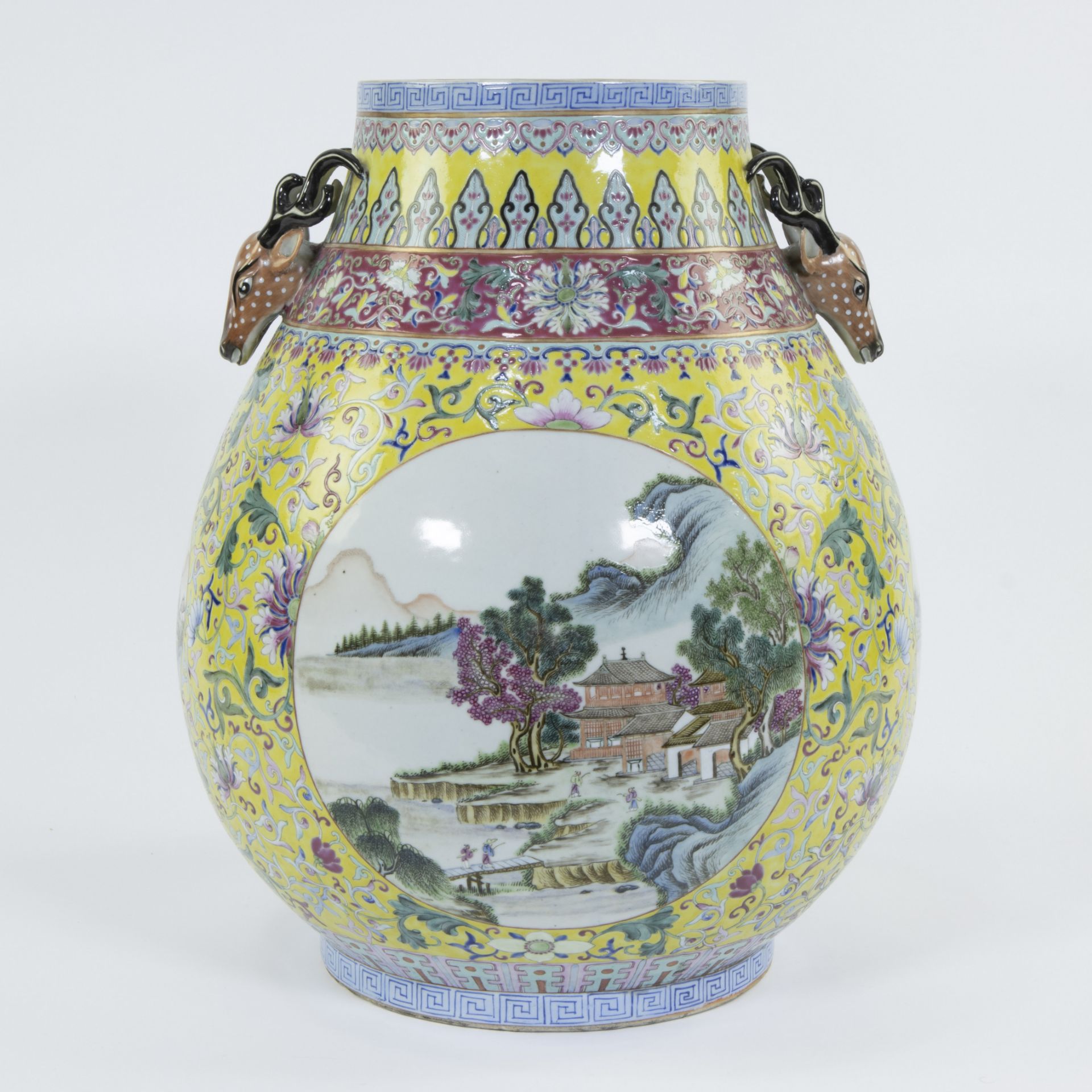 A vase of Chinese porcelain with a famille rosedecor of peonies on yellow fond and landscapes in car