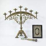 A semi-circle shape brass candle holder with seven branches, magnifying glass and framed relic