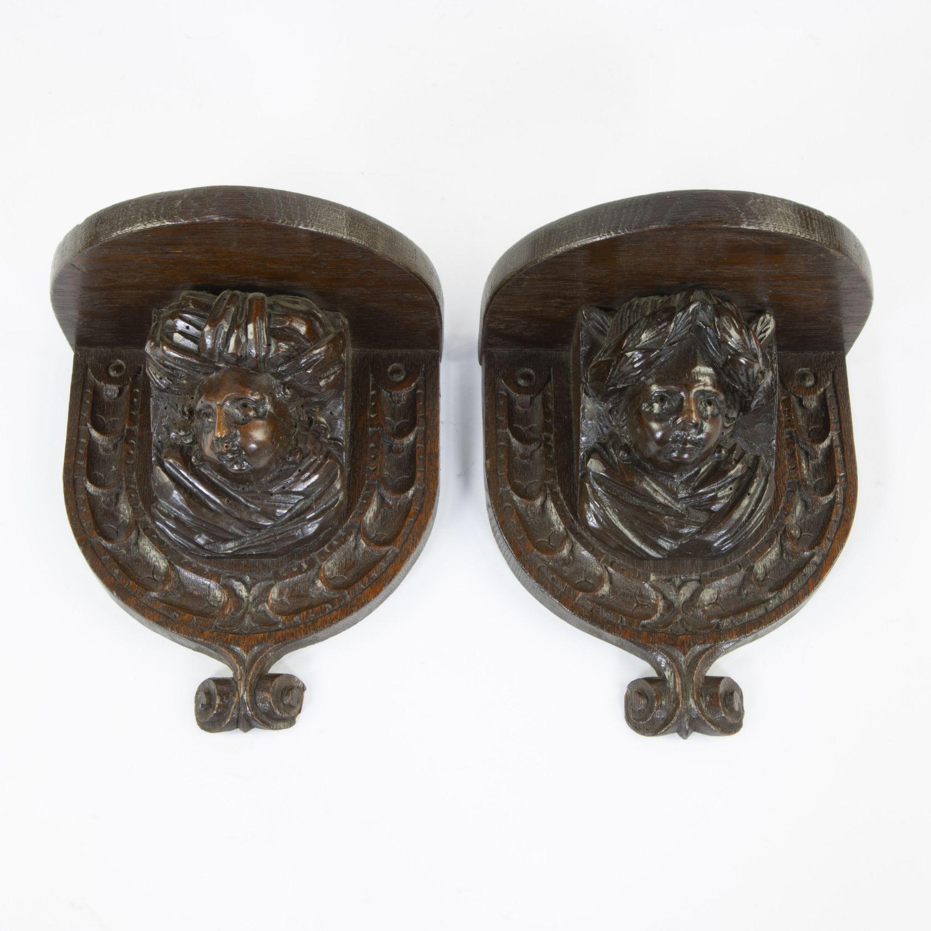 Pair of wooden hanging consoles with boys adorned with a turban