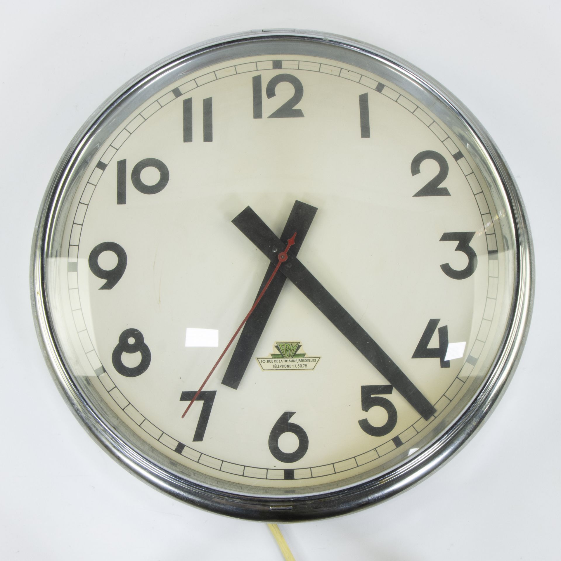 Wall clock FMB Brussels from the American theatre