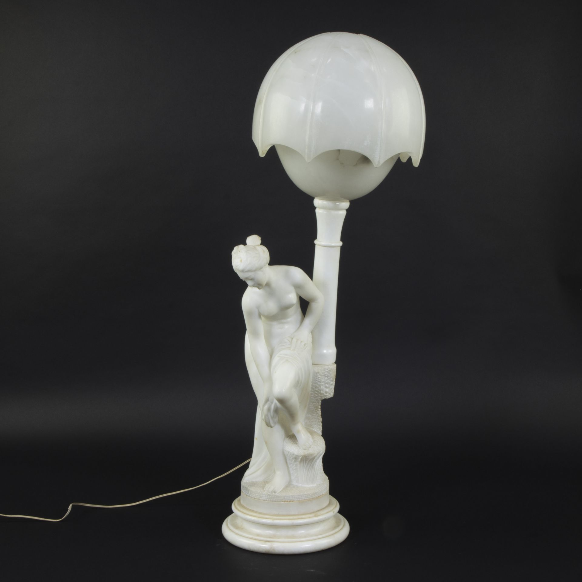 An alabaster and Carrara marble table lamp, decorated with the sculpture of a nude with towel, after