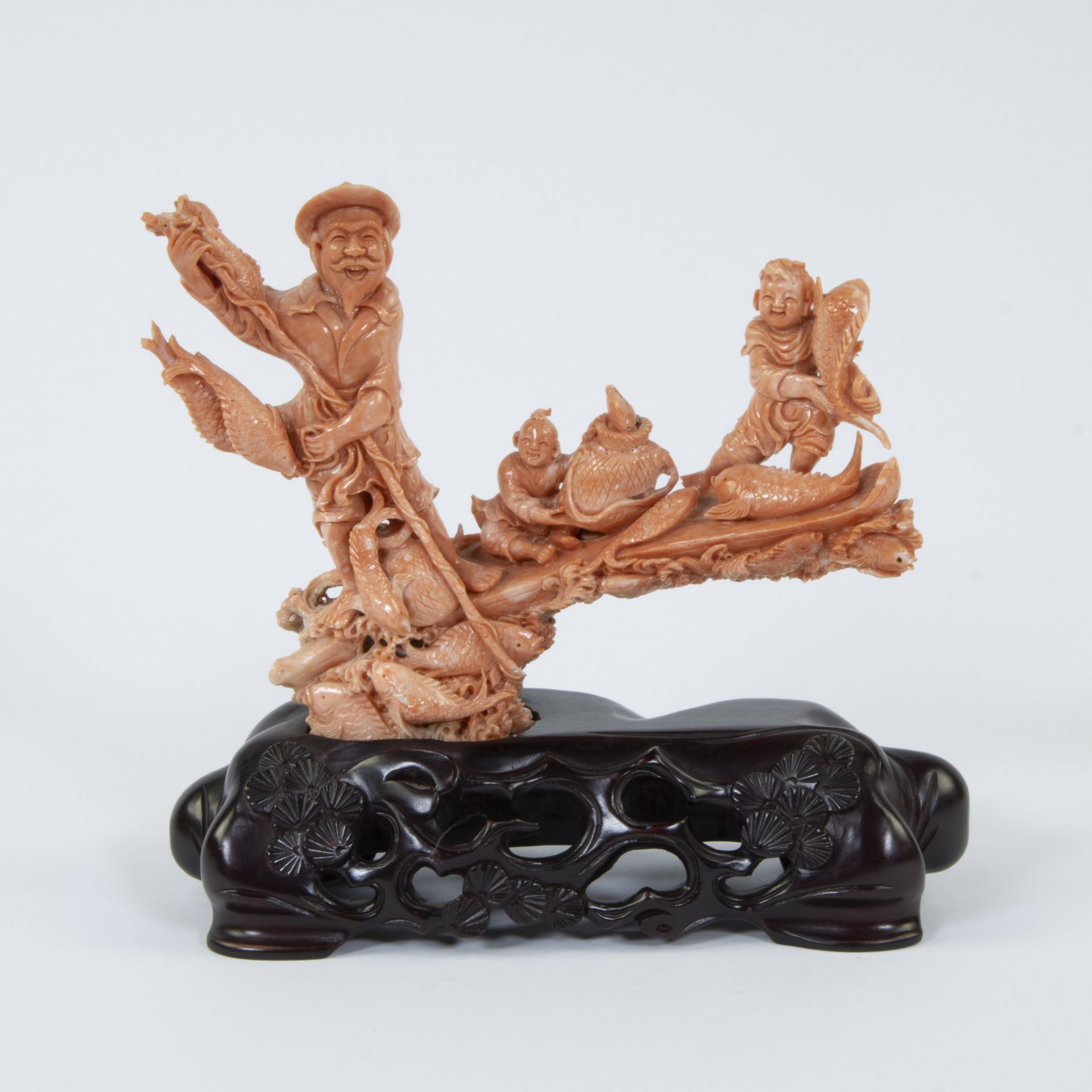 A Chinese group in red coral with a fisherman, children and fishes, 19/20th century