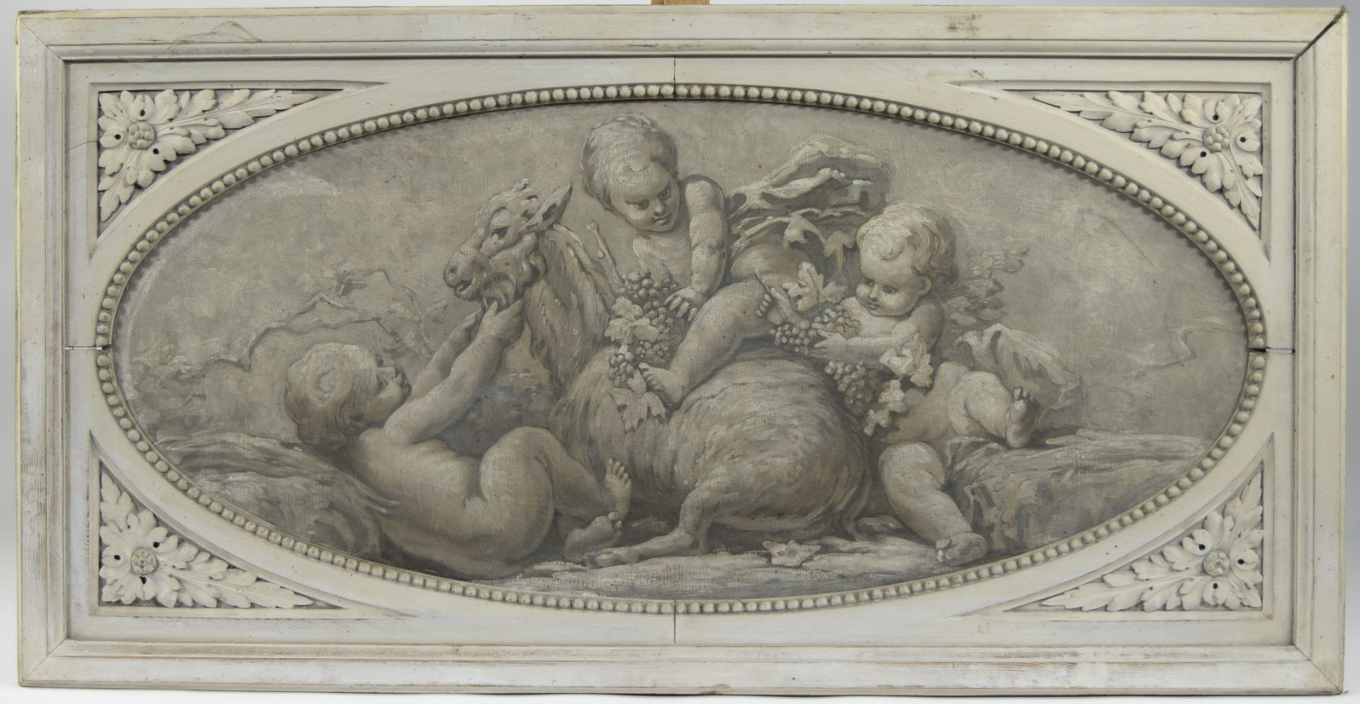 A decorative oval oil on canvas with allegorical depiction of putti in white stained ornamental fram