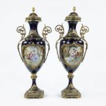 A pair of Sèvres ornamental vases of cobalt blue porcelain and gilt brass and decorated with multi-c