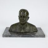 Patinated bronze male head on green-veined marble base, signed Joris Gen and dated 1929